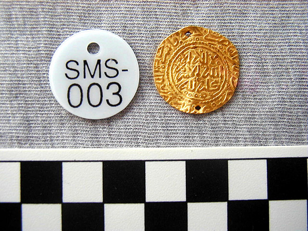 A gold coin from the wreck of the Fiery Dragon site.